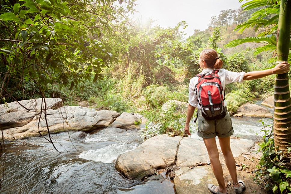 Woman exploring a rocky river on an Adventure Travel experience. Create your own thrilling adventures. 