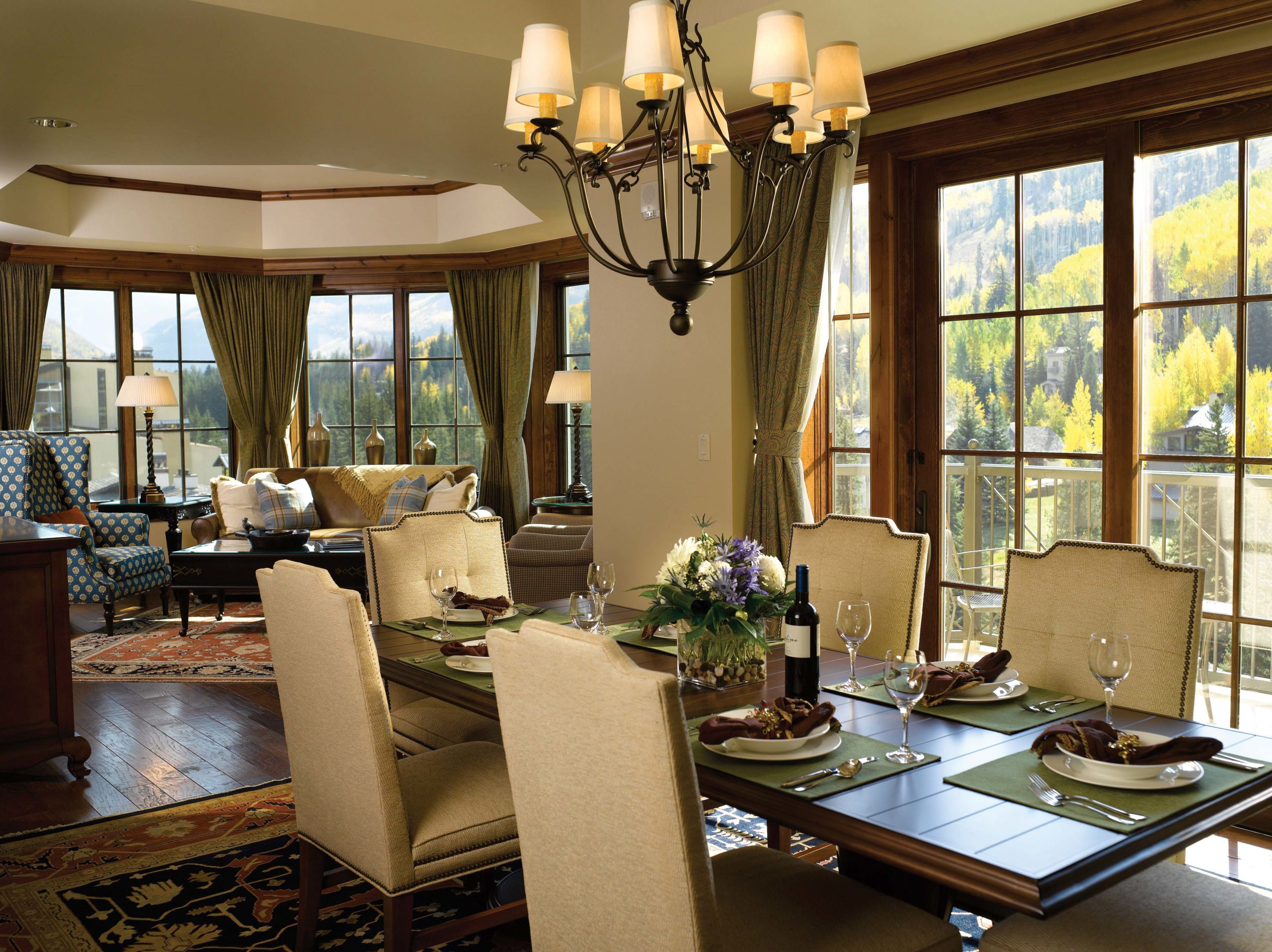 Lavish grand dining room with chandeliers and table settings