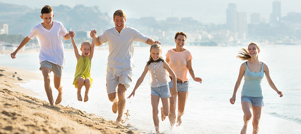 Family running on the beach