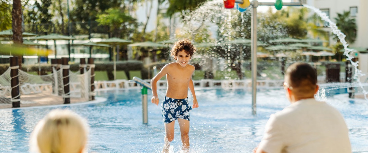 Couple watching their child play in the pool