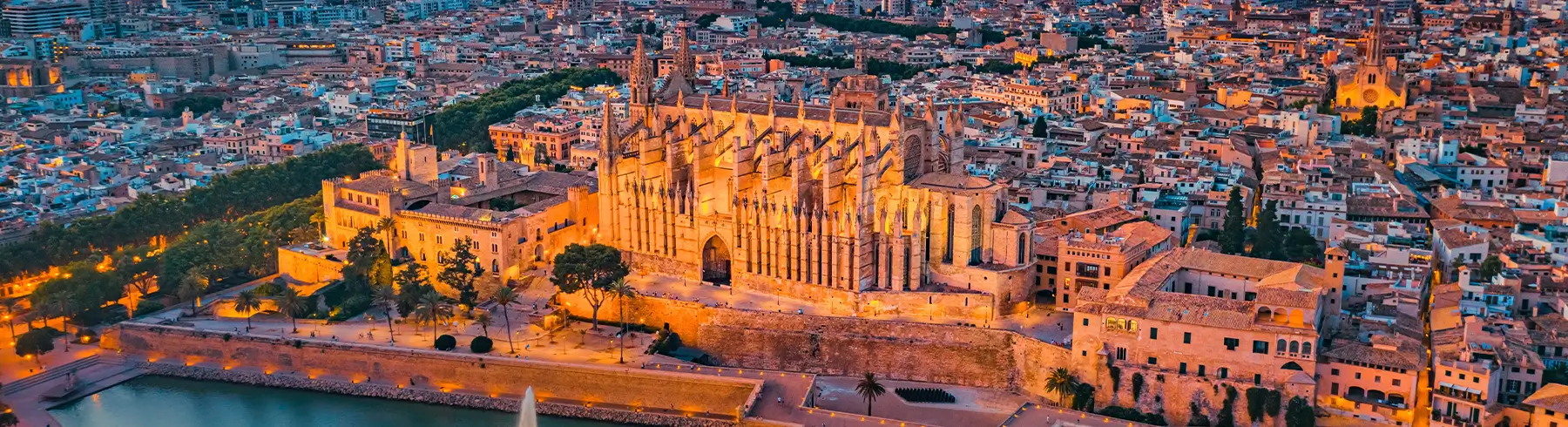 Aerial view of Palma Cathedral illuminated at sunset in Mallorca, Spain.