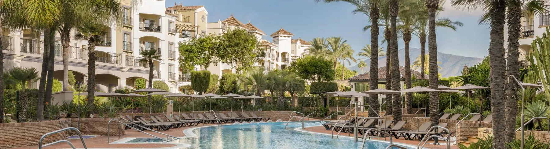 Pool area surrounded by palm trees and lush landscaping at Marriott's Playa Andaluza